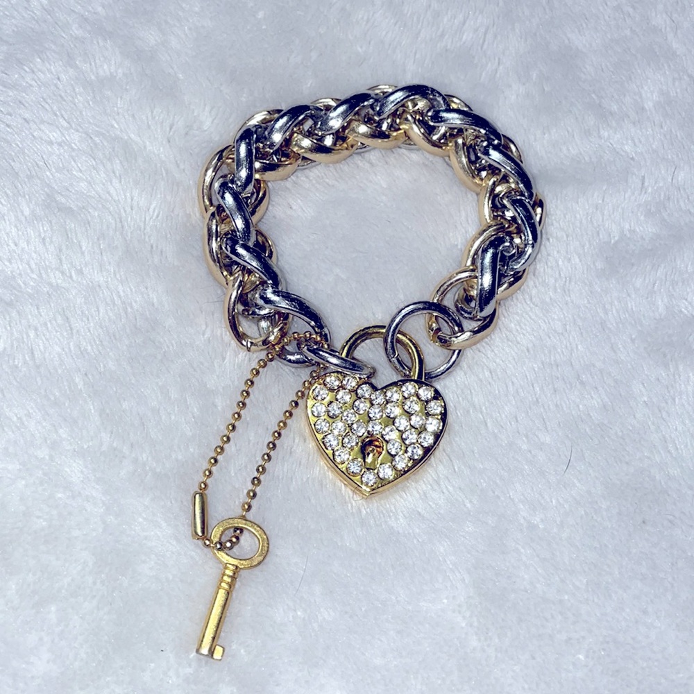Silver and gold metal bracelet with lock charm